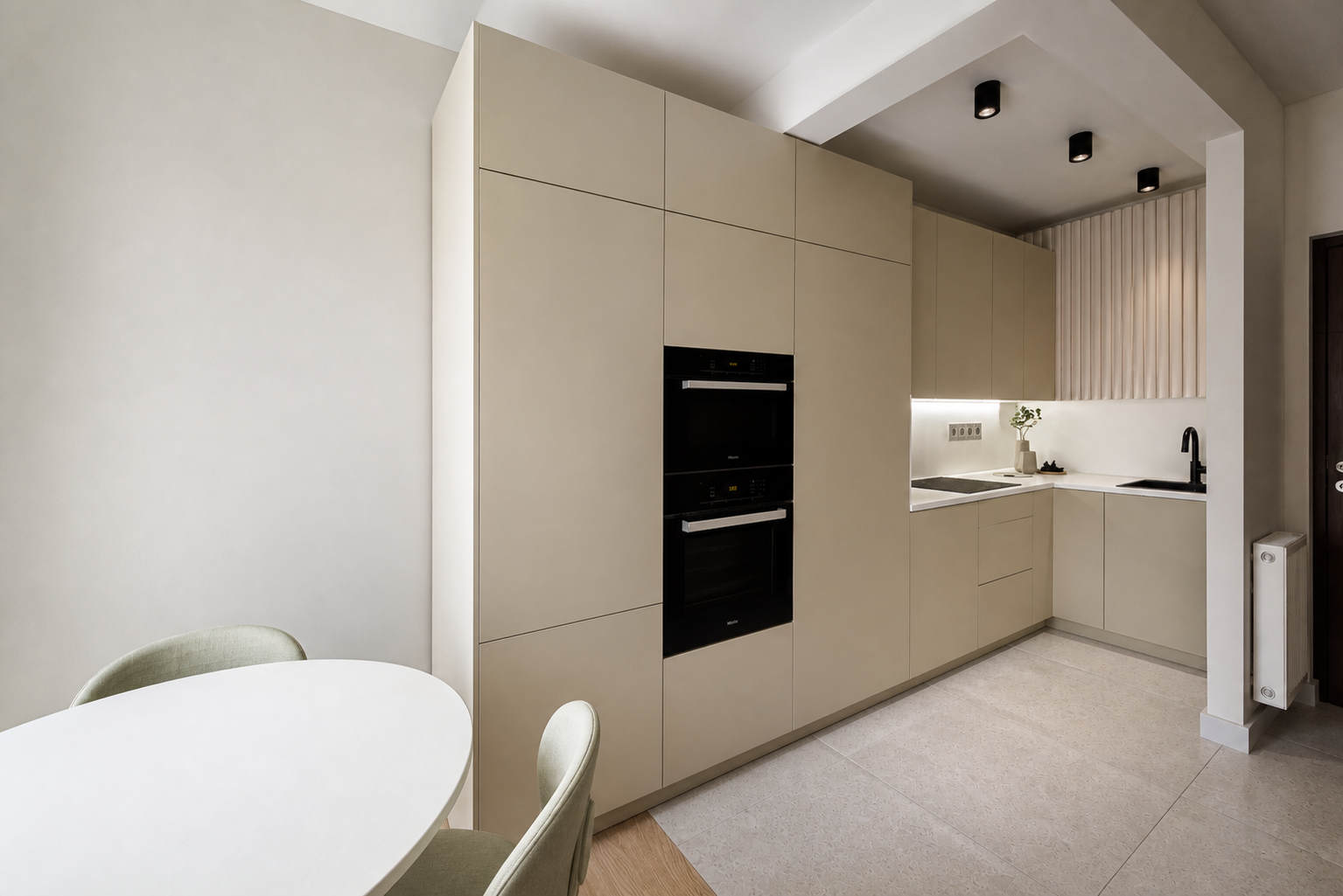 Minimal compact kitchen with integrated appliances and pale cabinetry